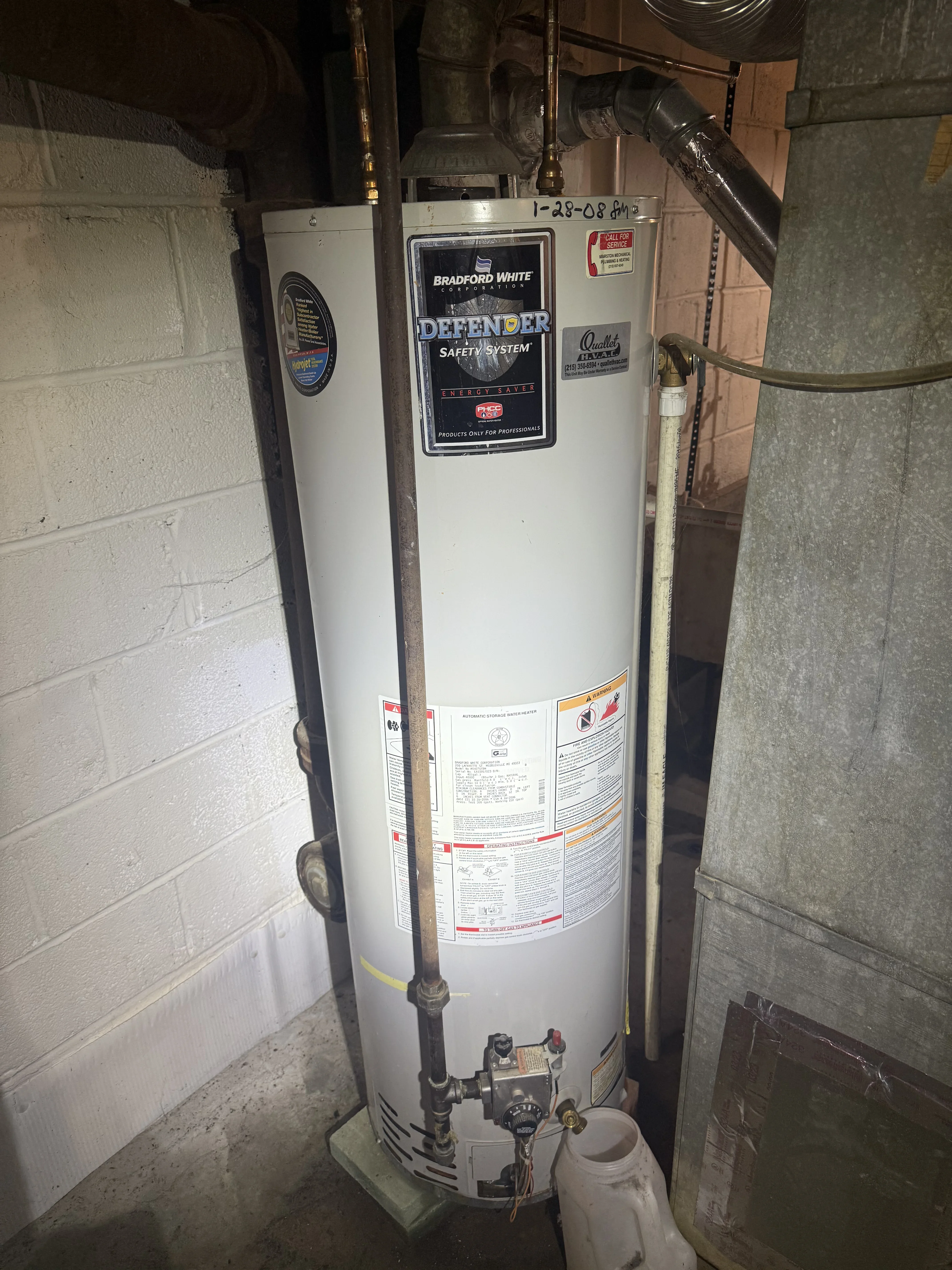 Bradford White Defender gas water heater with safety system, brass fittings, and vent pipe installation